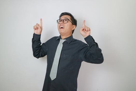 asian office man wearing black shirt pointing up, office man concept. photo