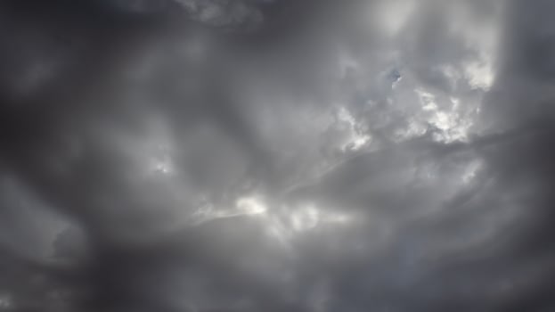 Beautiful dark dramatic sky with stormy clouds before rain or snow. Thunderstorm heaven landscape. Timelapse. photo