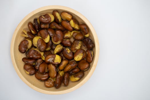 Koro beans in a wooden bowl on a white background photo