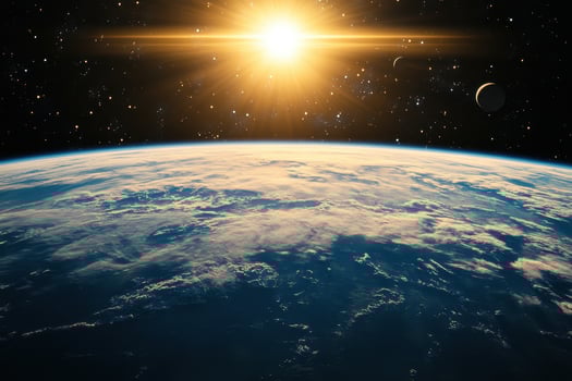 Sunrise over Earth from space, with the sun shining brightly. photo