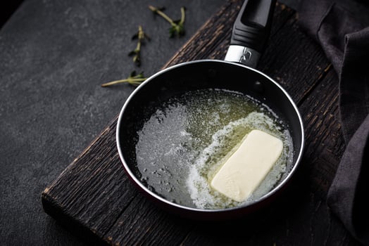 Melted butter on in iron pan photo