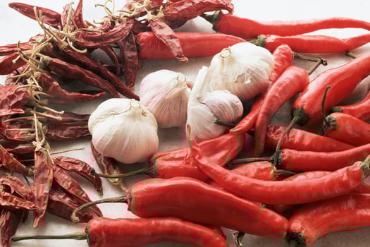 A pile of red peppers and garlic photo