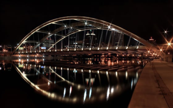 Midnight Cityscape Reflected in a Tie-Arch Bridge over Water photo