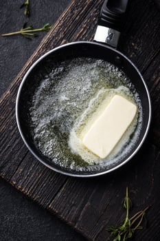 Melted butter on in iron pan photo