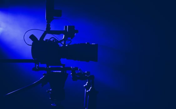 Camera Setup in a Dimly Lit Studio With Blue Lighting for a Film Project photo