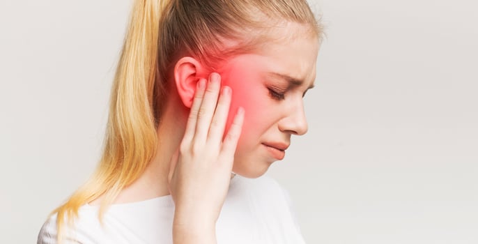 Tinnitus. Profile of sick female having ear pain, touching her painful head, panorama photo