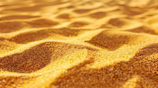 Close-up View of Golden Sand Dunes with Sunlit Texture photo