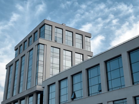 Modern office building in a corporate cityscape. Commercial structure exterior, sky. Smart photo