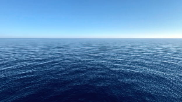Serene surface of the ocean under clear blue sky during daytime photo