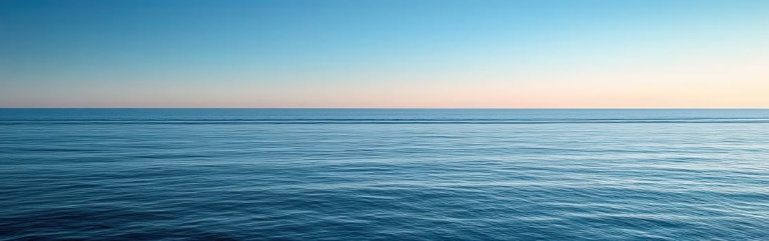 Calm ocean horizon at dusk with gentle waves and clear sky photo