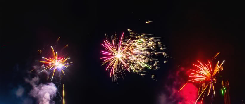 Collage of festive fireworks in the night sky. Several fireworks on a black background. photo