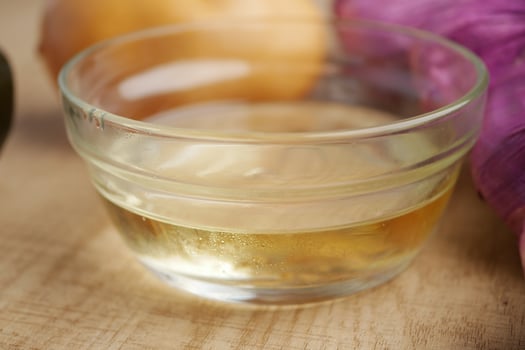 A Clear Liquid in a Glass Bowl that is Surrounded by a Variety of Fresh Ingredients photo