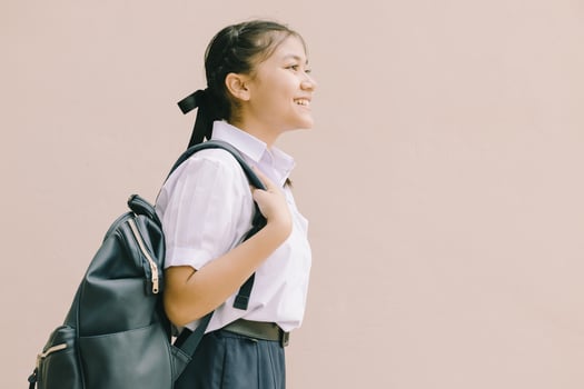 Portrait Thai Asian School girl teen cute student in uniform standing happy smile with shoulder bag isolated space for text. photo