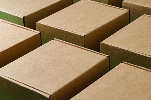 A close view of multiple brown cardboard boxes stacked closely in a warehouse photo
