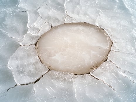 Frozen lake with cracked ice surface photo