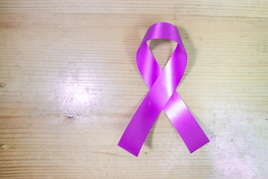 Pink ribbon on wood background for supporting World Cancer Day campaign on February. photo
