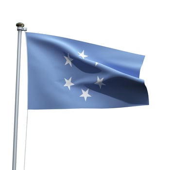 Micronesia flag on a pole waving isolated on white background photo