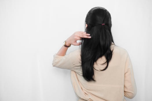 Expression of Indonesian Asian model woman in white holding hair photo