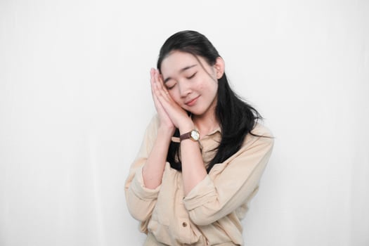 Expression of an Indonesian Asian model woman in white sleeping beautifully photo