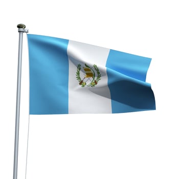 Guatemala flag on a pole waving isolated on white background photo