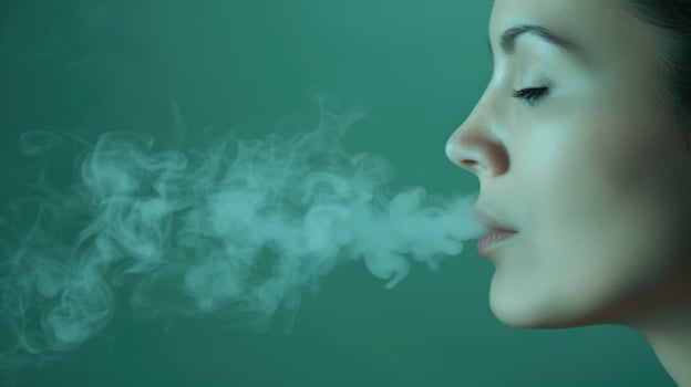 Closeup of a person exhaling smoke photo