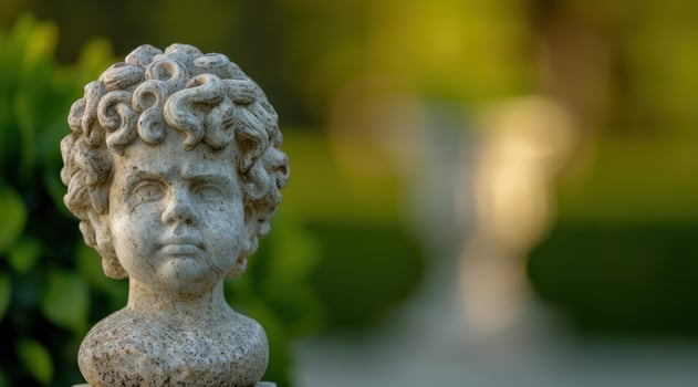 Weathered stone bust in a garden setting photo