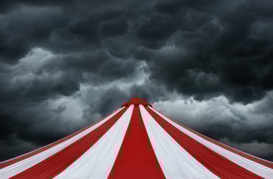 Dramatic circus tent under stormy sky photo