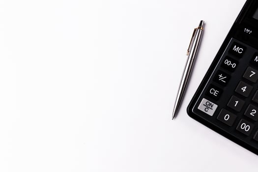 Calculator and pen on white background. Business background. Copy space photo