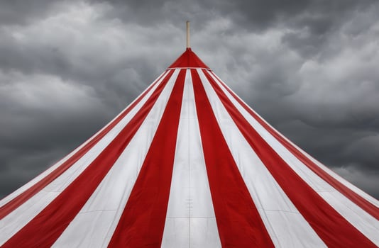 Dramatic circus tent under stormy sky photo