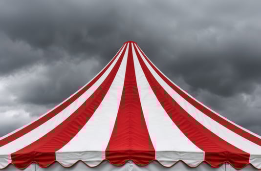 Vibrant circus tent against stormy sky photo
