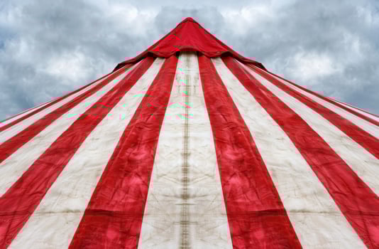Dramatic circus tent against cloudy sky photo