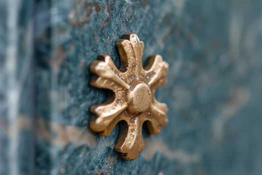 Ornate golden cross on a weathered blue surface photo