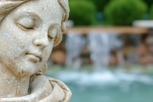 Weathered stone sculpture in a serene garden setting photo