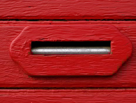 red wooden surface with metal slot photo