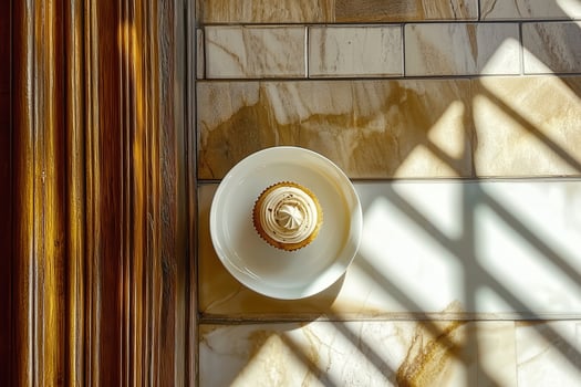 Golden Marble Shadows Enhancing a Perfectly Plated Cupcake photo