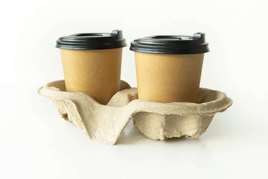 Takeaway paper coffee cups with plastic lids and cardboard holder in cardboard holder on white background, eco friendly, biodegradable photo