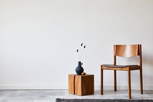 Stylish living room interior composition with creative design vintage chair, wooden cube and elegant personal accessories. Wallpaper. Copy space. Template. photo