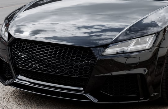 Modern car headlight close up photo
