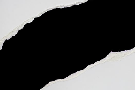 White ripped paper torn edges strips isolated on black background photo