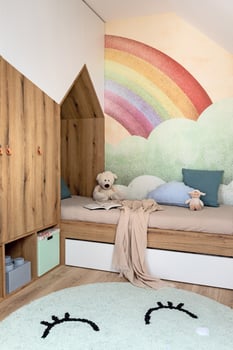 Stylish scandinavian kid room with toys, teddy bear, plush animal toys, furniture, kid accessories. Modern interior with rainbow background walls, Design interior of childroom. Template photo
