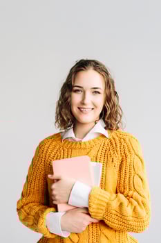 Smiling Woman Holding Digital Tablet. Happy young woman holding a digital tablet, standing against a white background. Perfect for online education, e-learning courses, digital technology photo