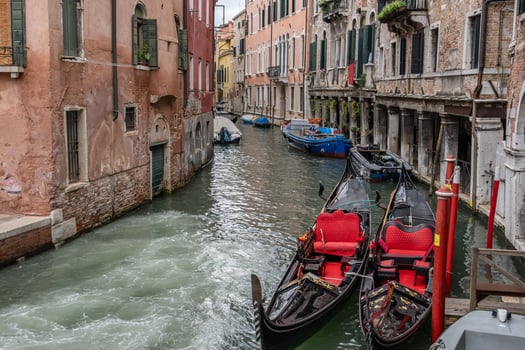 View on canal with boat and motorboat, Venice Italy. photo