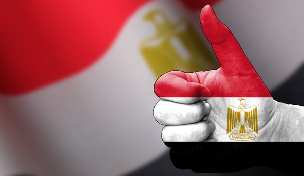 thumbs up in approval with the Egyptian flag painted, photo