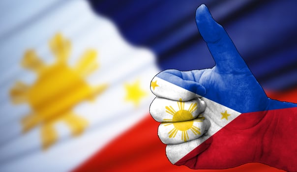thumbs up in approval with the Philippin flag painted, photo