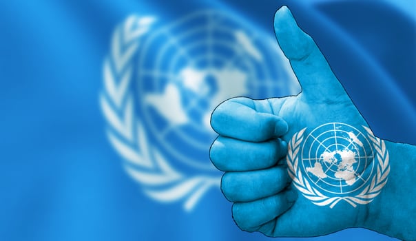 thumbs up in approval with the United Nations flag painted photo