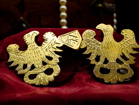 close up shot reproduction of decorated jewelry ancient rome with decoration of the roman eagle. photo