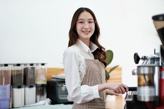 Dedicated barista preparing coffee, demonstrating professionalism and skill in a cafe setting. photo