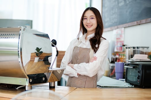 Confident small business owner at a cafe counter, radiating professionalism and hospitality. photo
