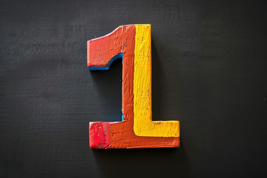A wooden number 1 with a red, yellow and blue paint job photo