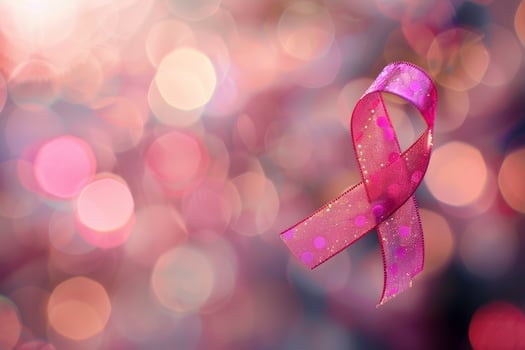 The pink ribbon stands out vividly against a blurred, sparkling background, highlighting its significance in promoting breast cancer awareness and support efforts photo